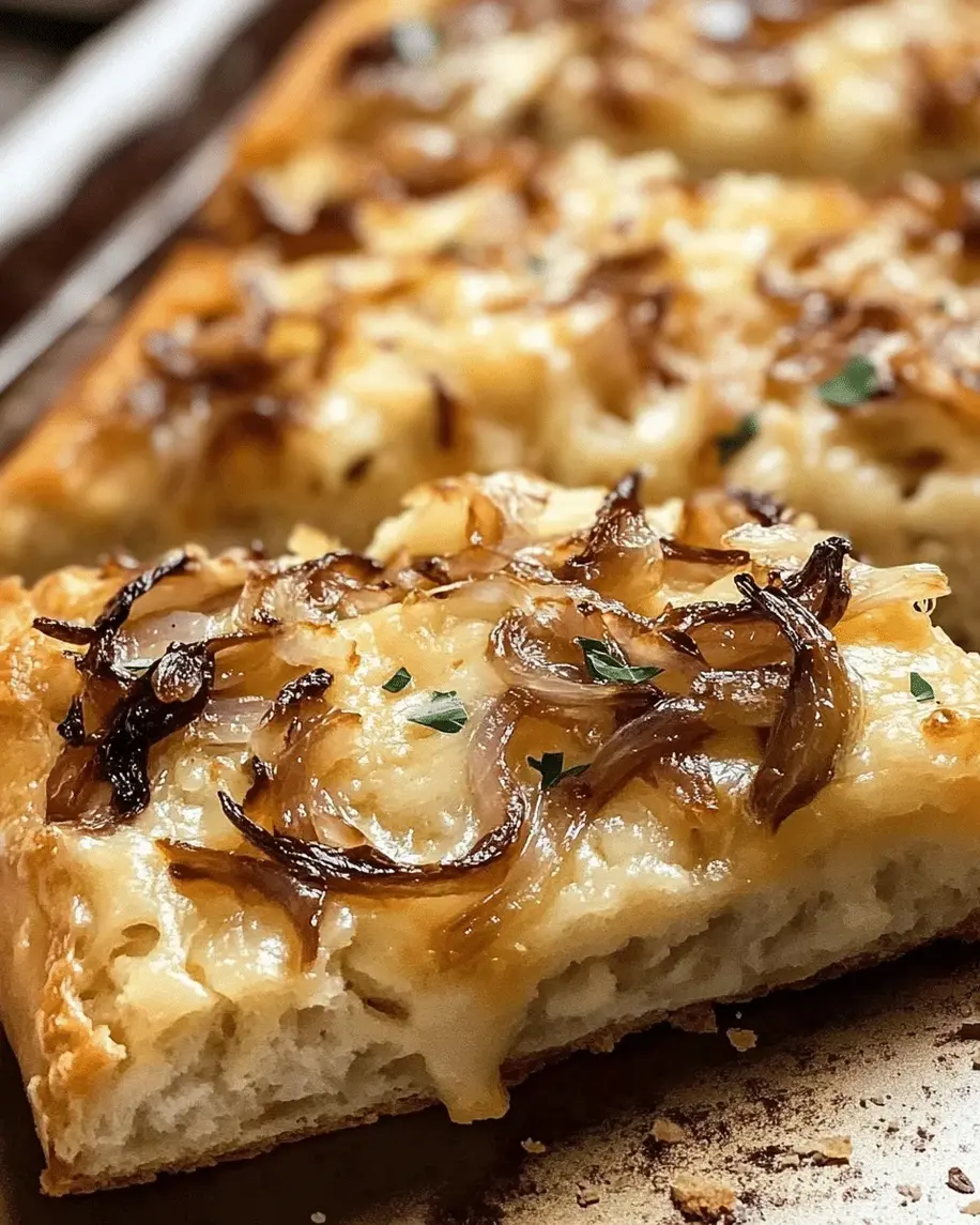 Close-up of sliced Caramelized Onion and Cheddar Focaccia, highlighting the melty cheese and onions.