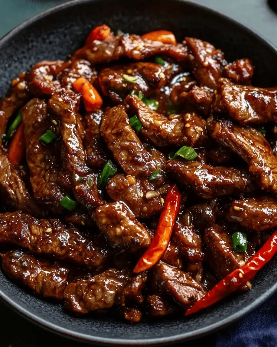 Preparation area showing thinly sliced sirloin steak coated in cornstarch, ready for the Crispy Stir-Fried Sirloin Steak with Sweet Chili Sauce recipe