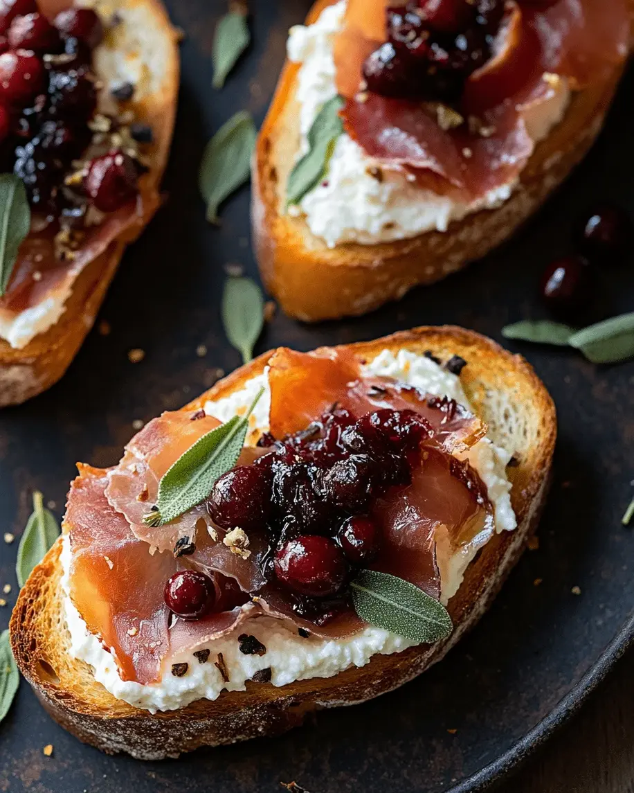 Savory Cranberry Ricotta Toast with Prosciutto and Fresh Sage on a rustic wooden board.