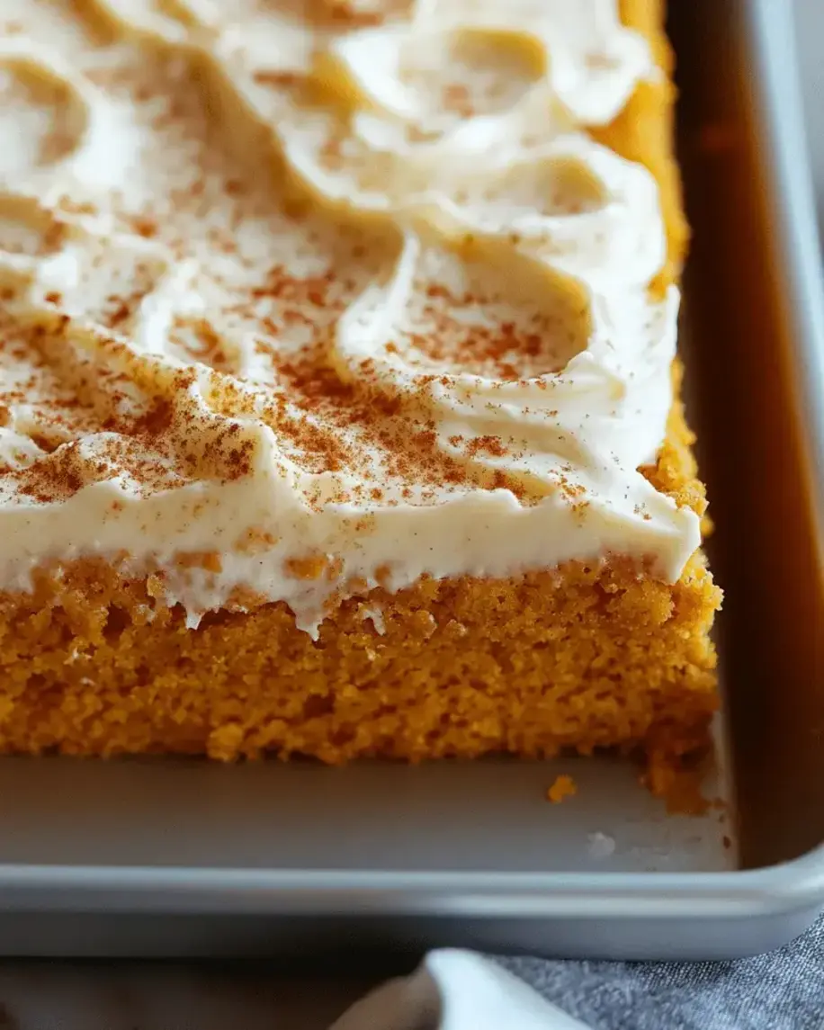 Close-up of pumpkin spice cake with cream cheese icing.