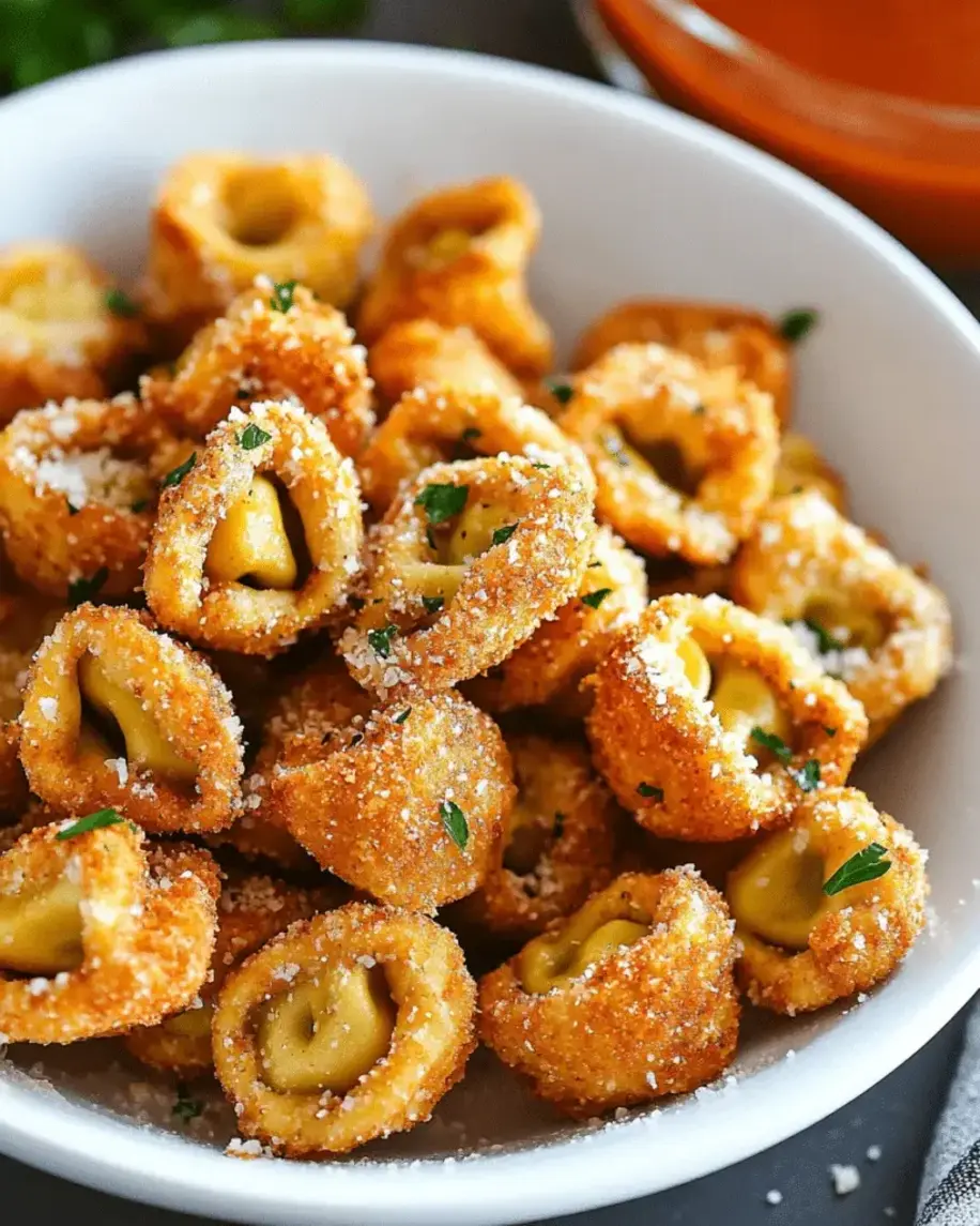 Close-up of crispy fried tortellini with a side of marinara sauce for dipping.