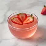 High-protein bariatric gelatin recipe in a small glass bowl garnished with fresh strawberries — post-surgery recovery food