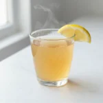 Horse gelatin for men daily tonic — clear golden collagen drink in a glass on a bright kitchen counter with morning light
